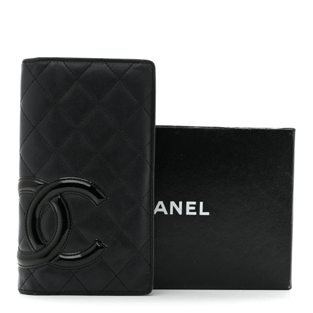 Black quilted Chanel wallet with logo on a white background