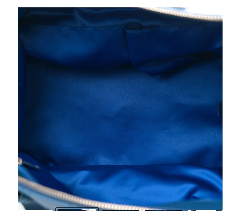 Close-up of a blue fabric interior with a zipper chanel blue lambskin handbag 