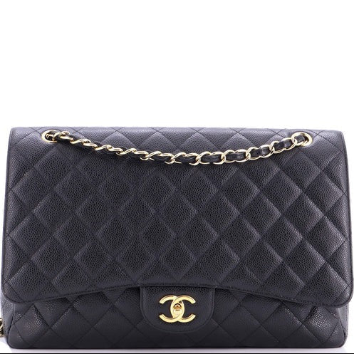 Black quilted handbag with gold chain and clasp on a white background