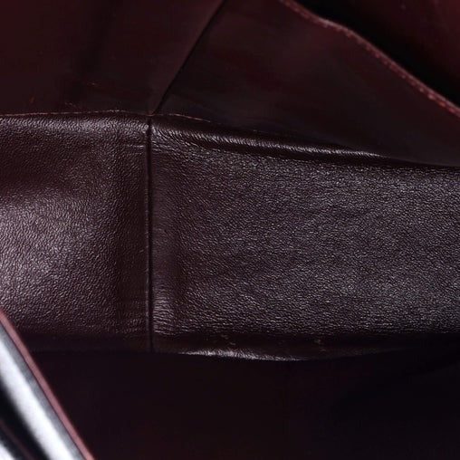 Close-up of dark brown leather surface with visible stitching