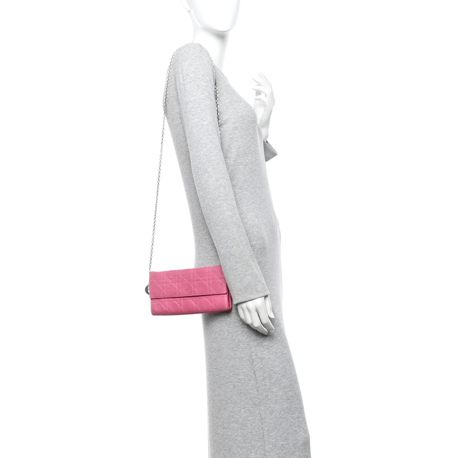 Mannequin wearing a gray dress with a pink CHRISTIAN DIOR WALLET ON CHAIN bag on a white background