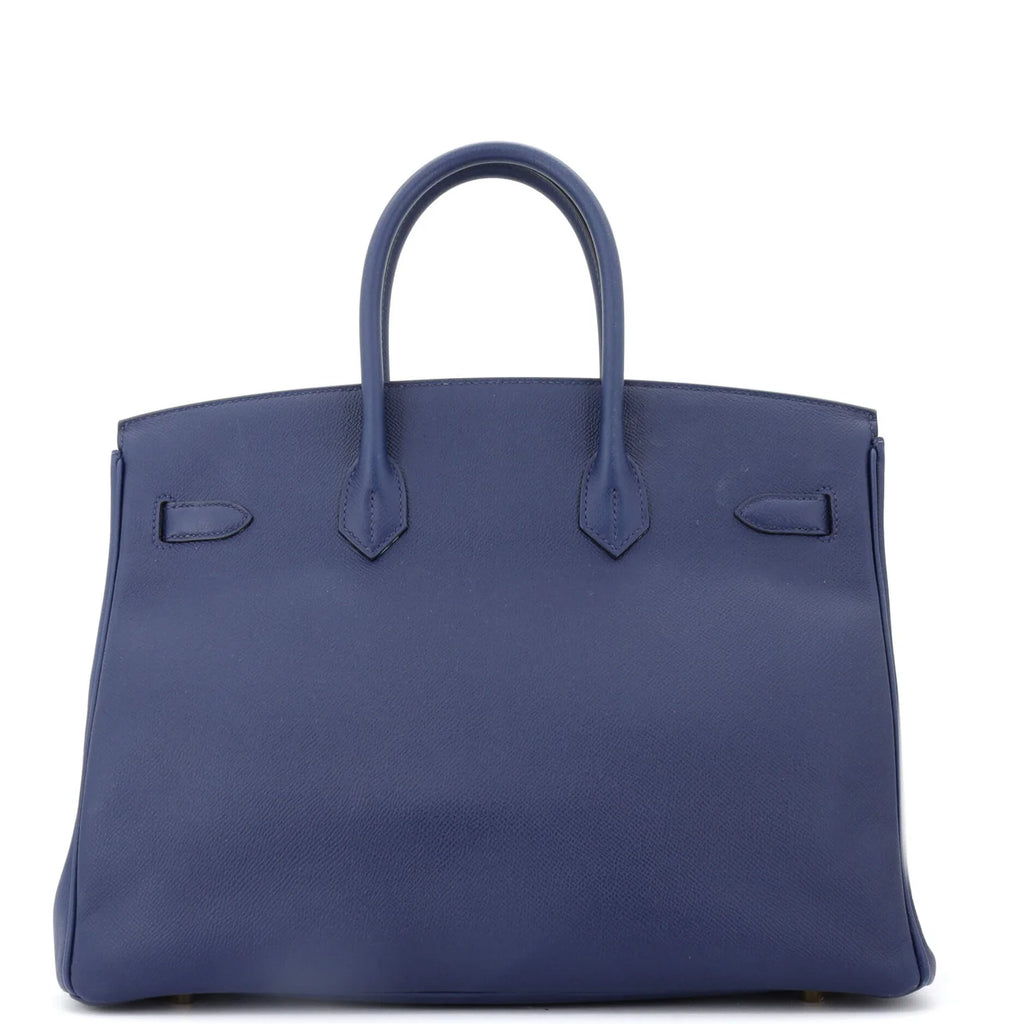 Blue Hermes Birkin handbag on a white background