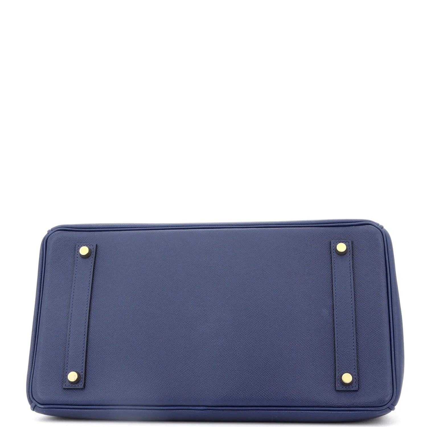 Underside of Blue Hermes Birkin bag with gold accents on a white background