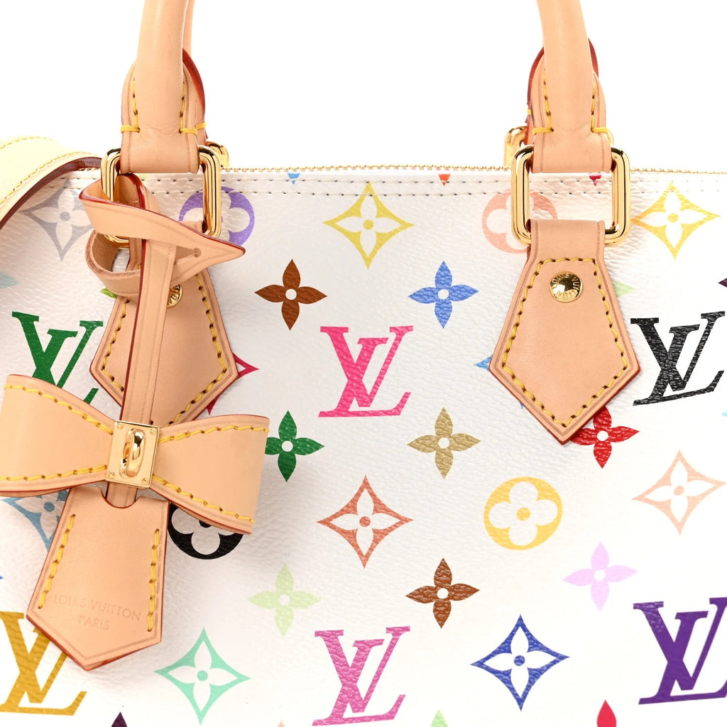Designer handbag with colorful monogram pattern and bow detail