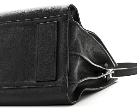 Black leather bag with a visible brand label on a white background