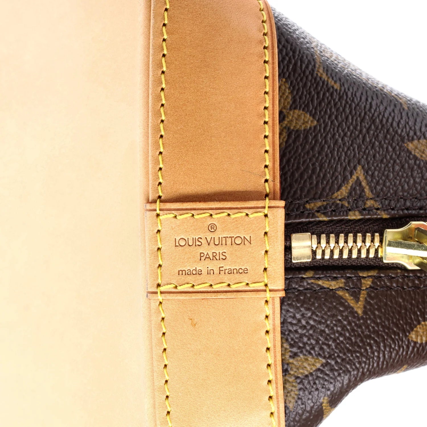 Close-up of a Louis Vuitton handbag with visible branding and gold zipper.