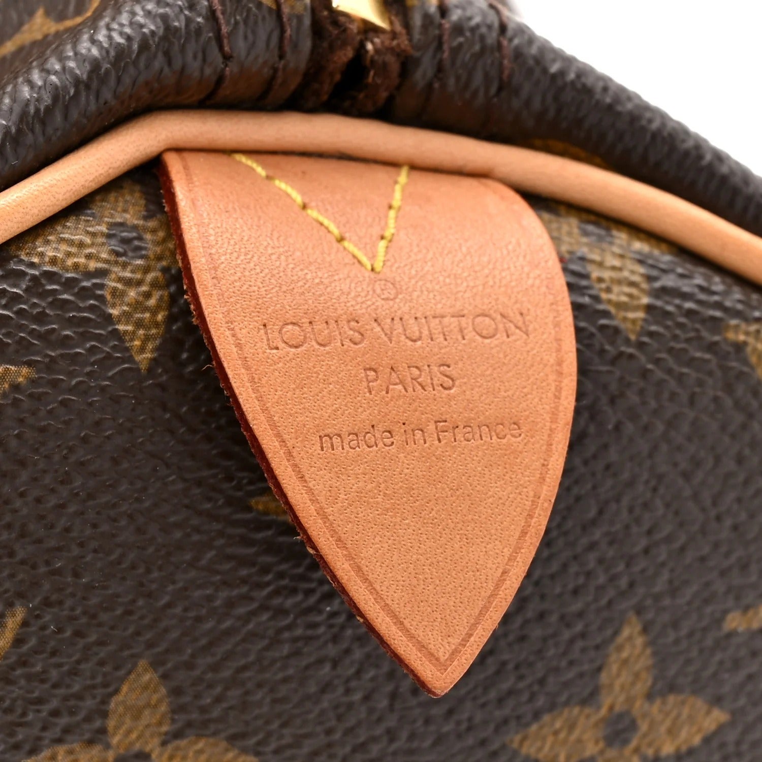 Close-up of a Louis Vuitton bag with the brand name and 'made in France' label.