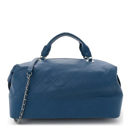 Blue quilted handbag with a chain detail on a white background chanel lambskin 