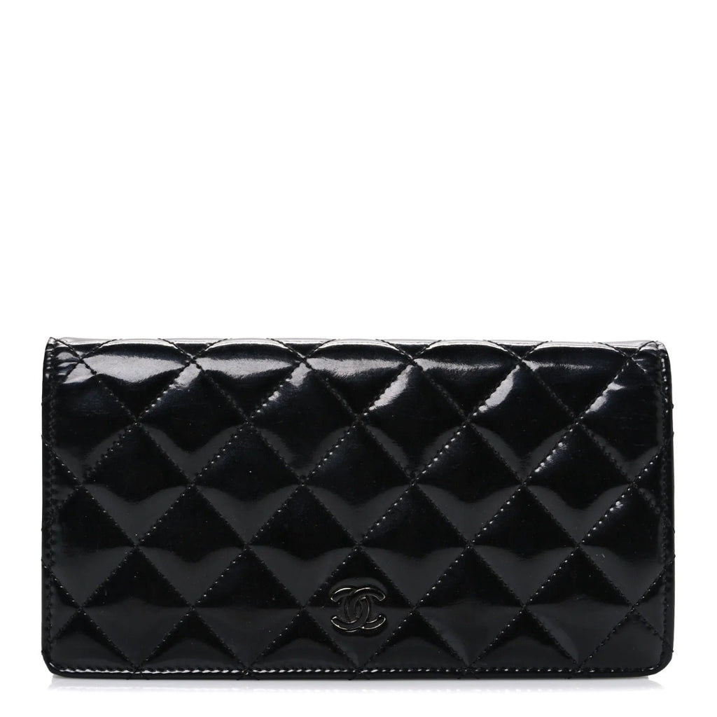 Black quilted wallet with Chanel logo on a white background