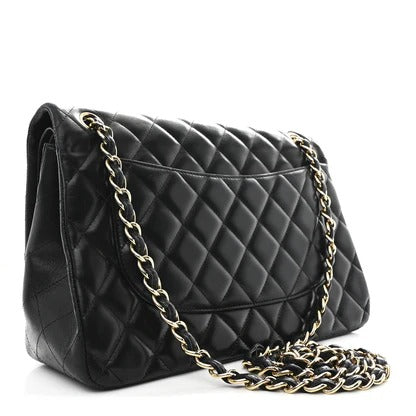 chanel jumbo lambskin Black quilted handbag with gold chain strap on a white background