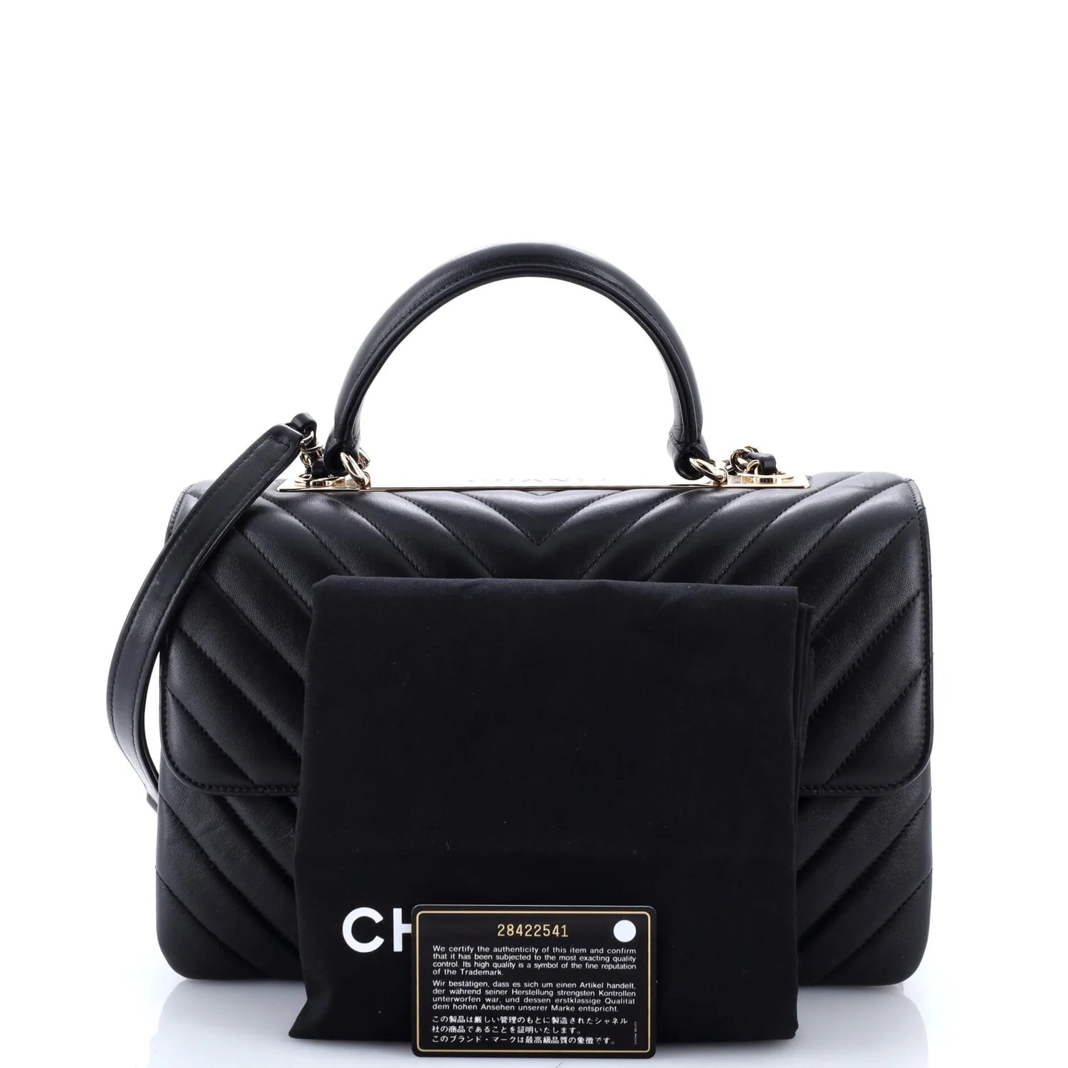 Black quilted classic Chanel leather handbag with matching pouch on a white background