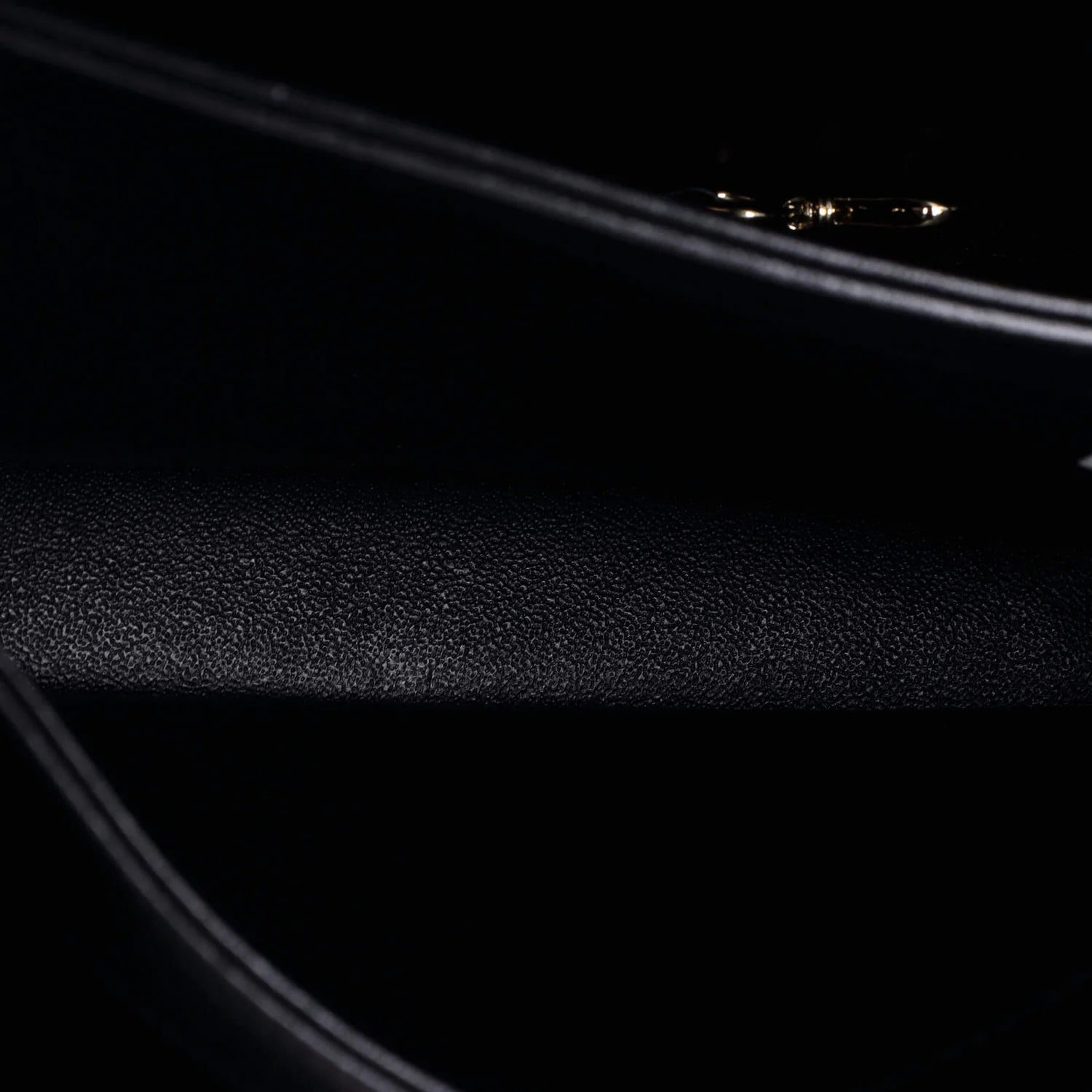 Interior close-up of textured black surface  of classic Chanel leather handbag 