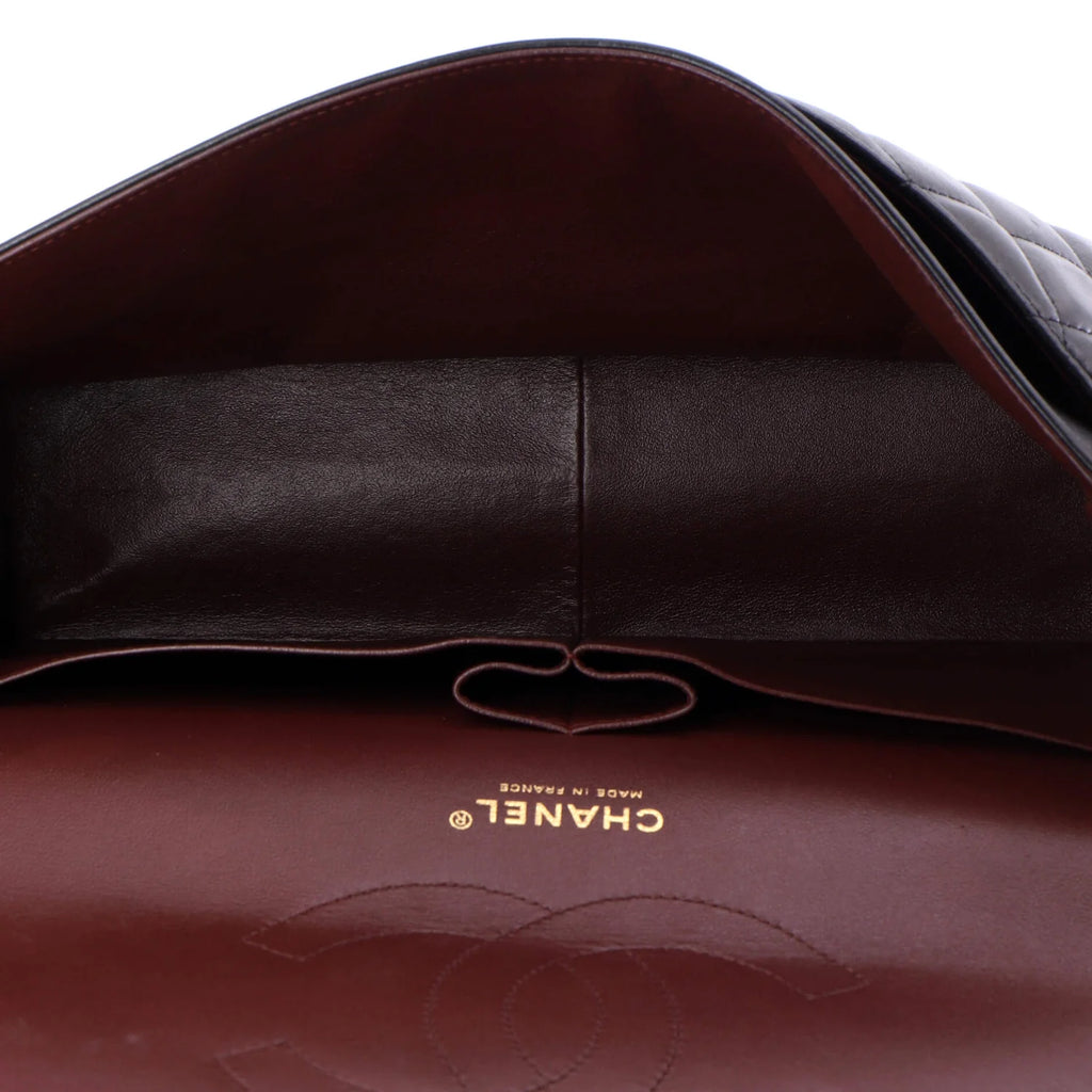 Close-up of a Chanel handbag red interior with visible logo on a white background