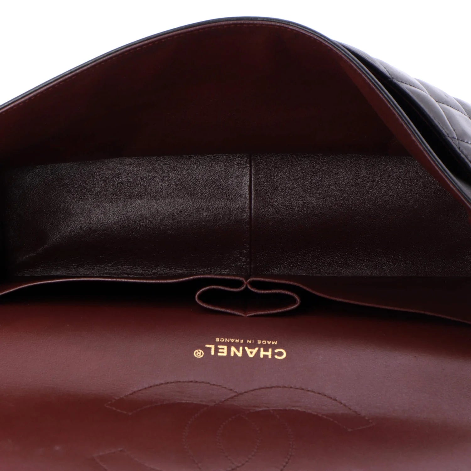 Close-up of a Chanel handbag red interior with visible logo on a white background