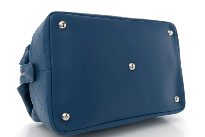 Blue handbag with silver studs on a white background chanel blue lambskin 