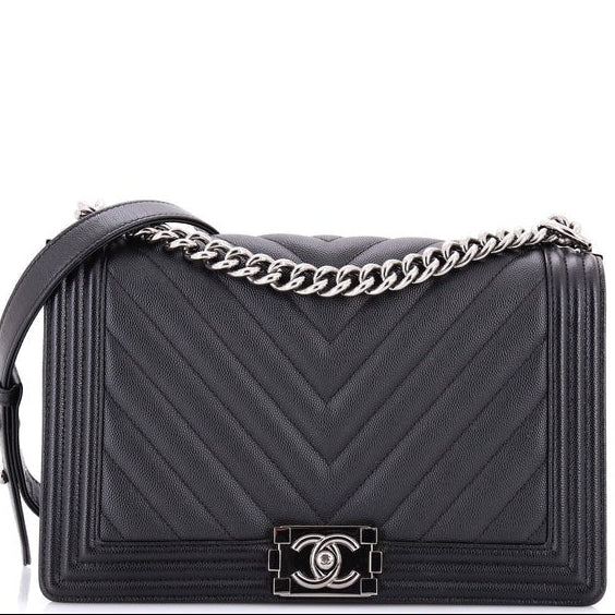 chanel boy bag caviar chevron handbag with a chain strap on a white background