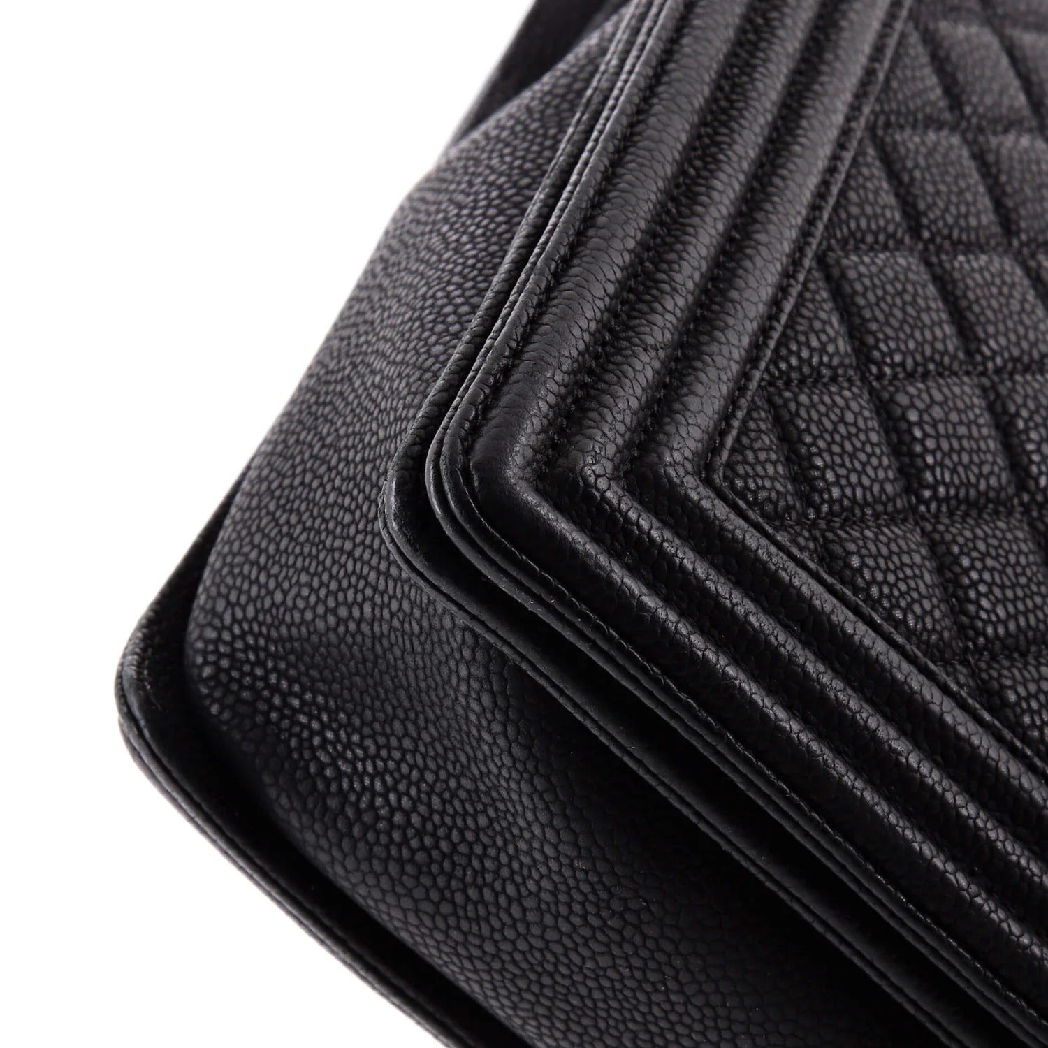 chanel caviar boy flap bag large Close-up of black car mats with textured surface on a white background