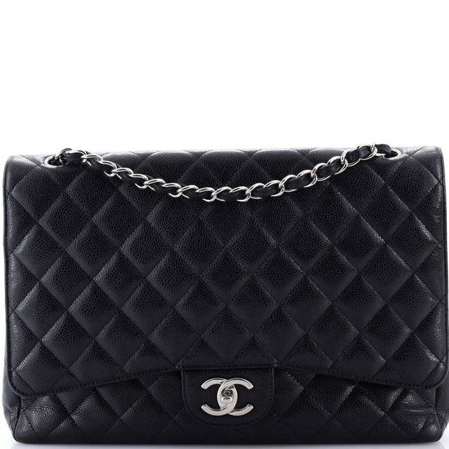 chanel caviar jumbo classic flap Black quilted handbag with silver chain strap on a white background