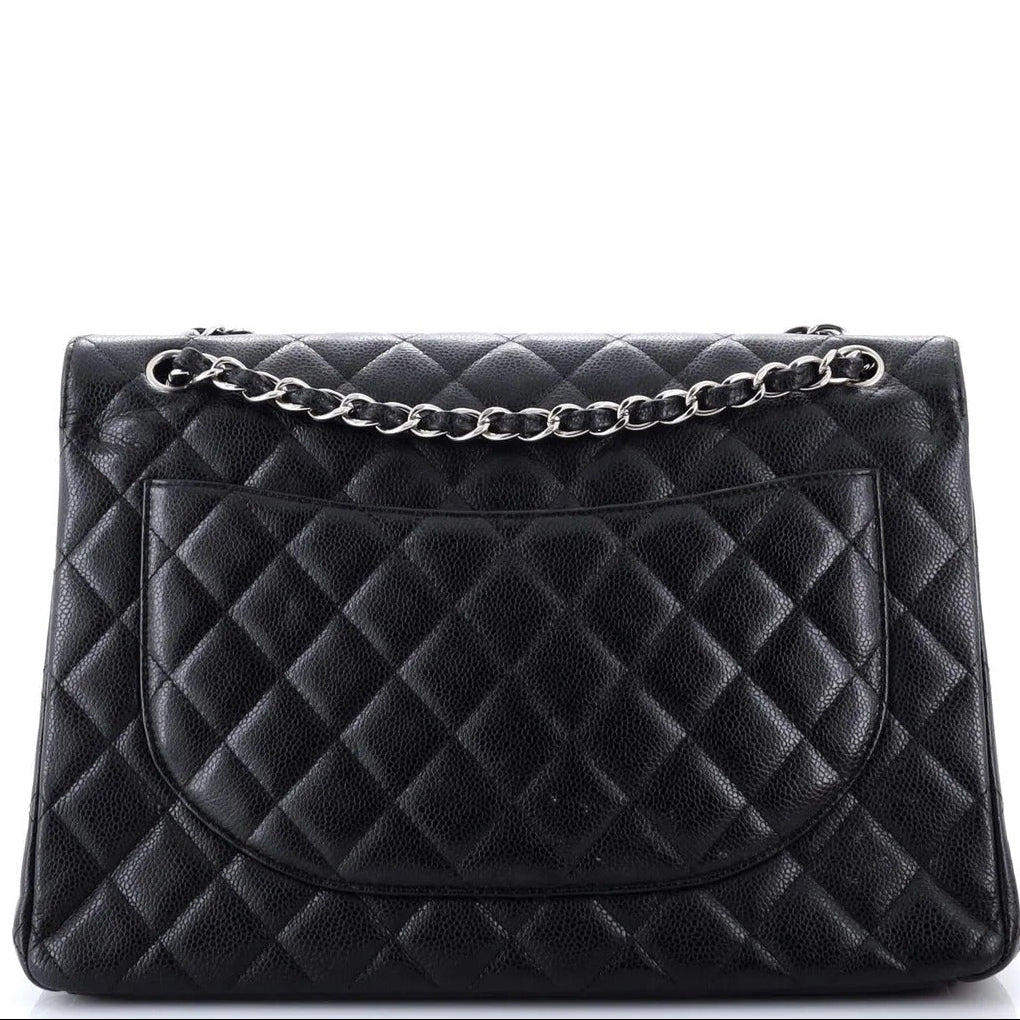 Black quilted handbag with a chain detail on a white background