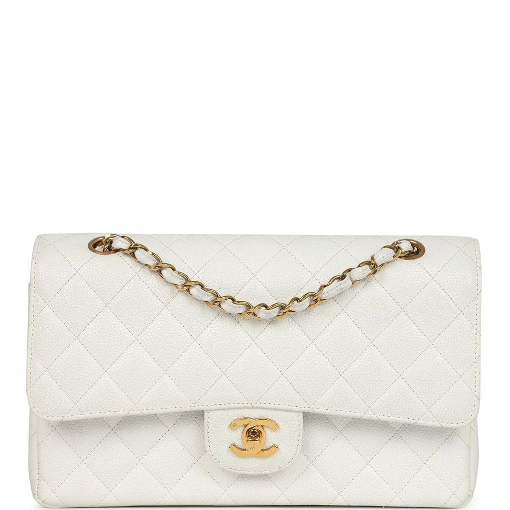 White quilted handbag with gold chain and clasp on a white background