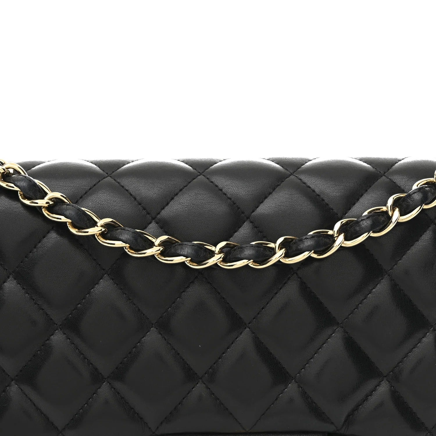 Black quilted handbag with a gold chain strap on a white background
