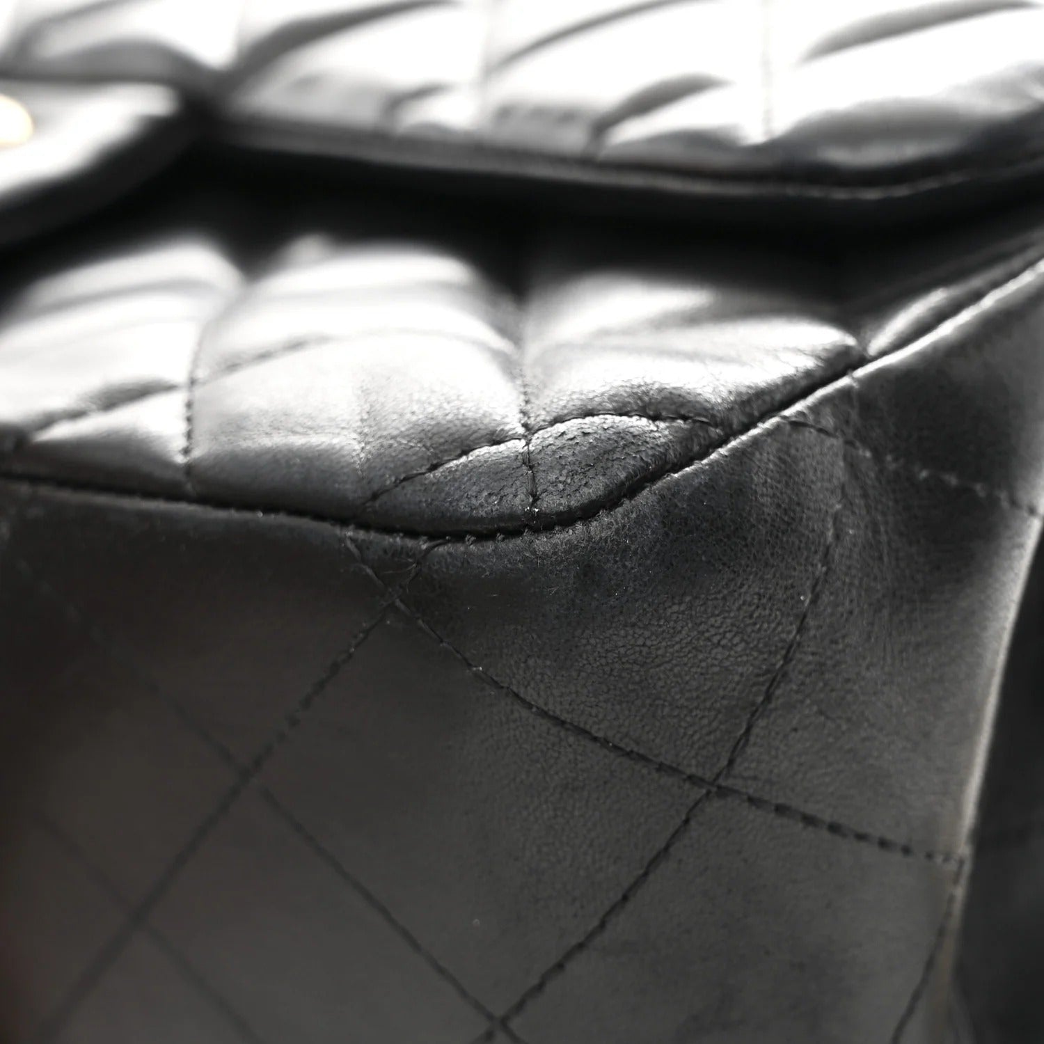 Close-up of a quilted black leather handbag chanel jumbo lambskin