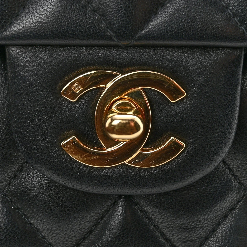 Black quilted handbag with gold Chanel logo