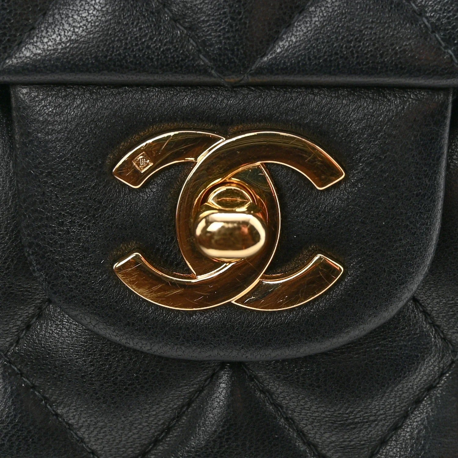 Black quilted handbag with gold Chanel logo