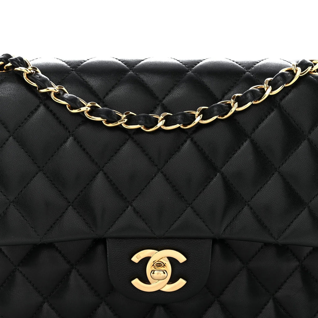 chanel lambskin medium double flap  Black quilted handbag with gold chain and logo on a white background