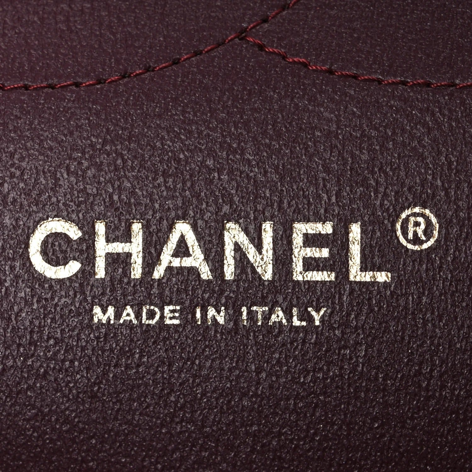 Chanel logo on a dark leather background with 'Made in Italy' text.