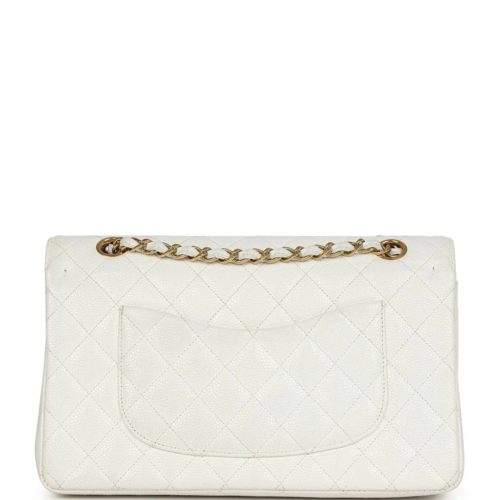 White quilted handbag with gold chain on a white background