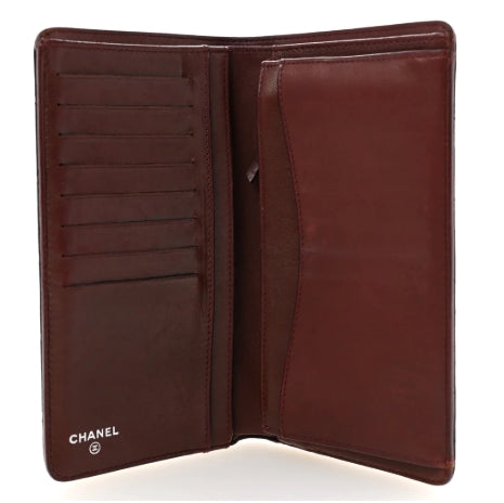 Brown leather wallet with Chanel logo on a white background