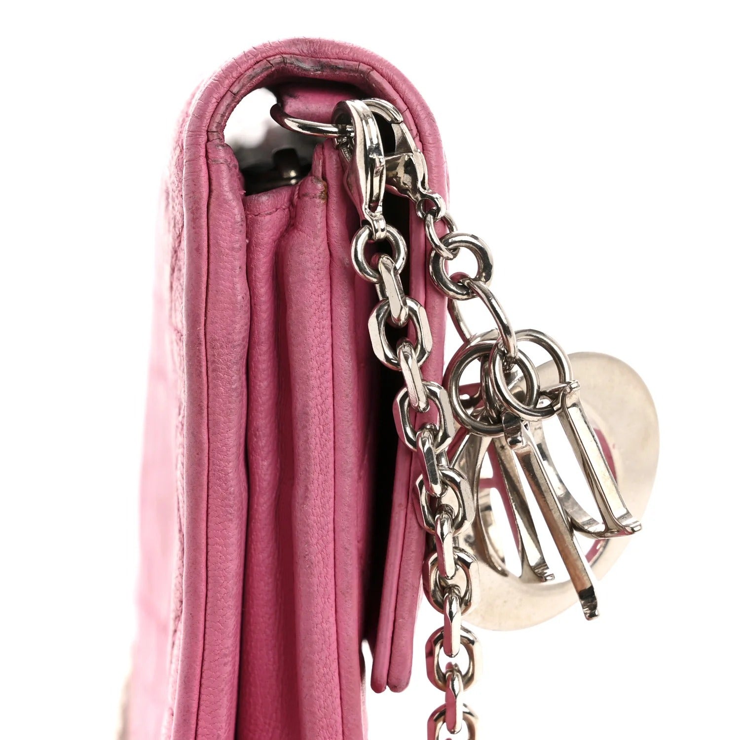 Pink handbag with silver chain and lock detail on a white background