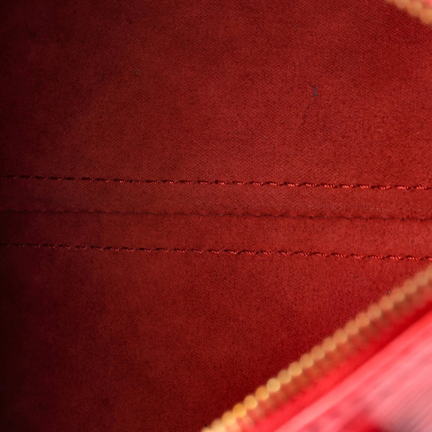 Close-up of a red fabric surface with stitching details