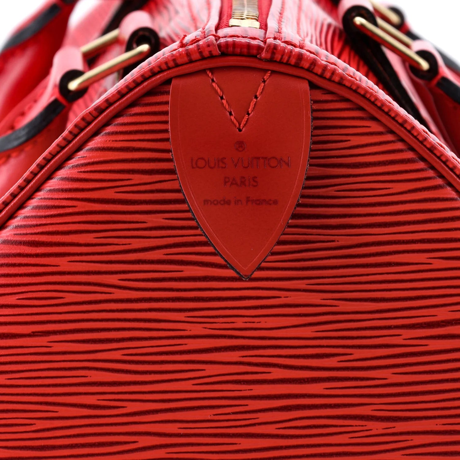 louis vuitton red epi speedy Close-up of a red Louis Vuitton handbag with visible branding.