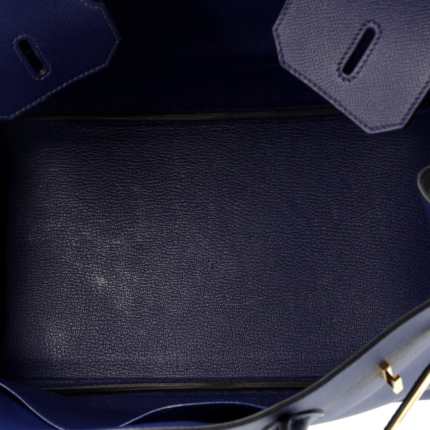 Close-up of a dark blue textured leather surface with geometric patterns in a Blue Hermes Birkin handbag