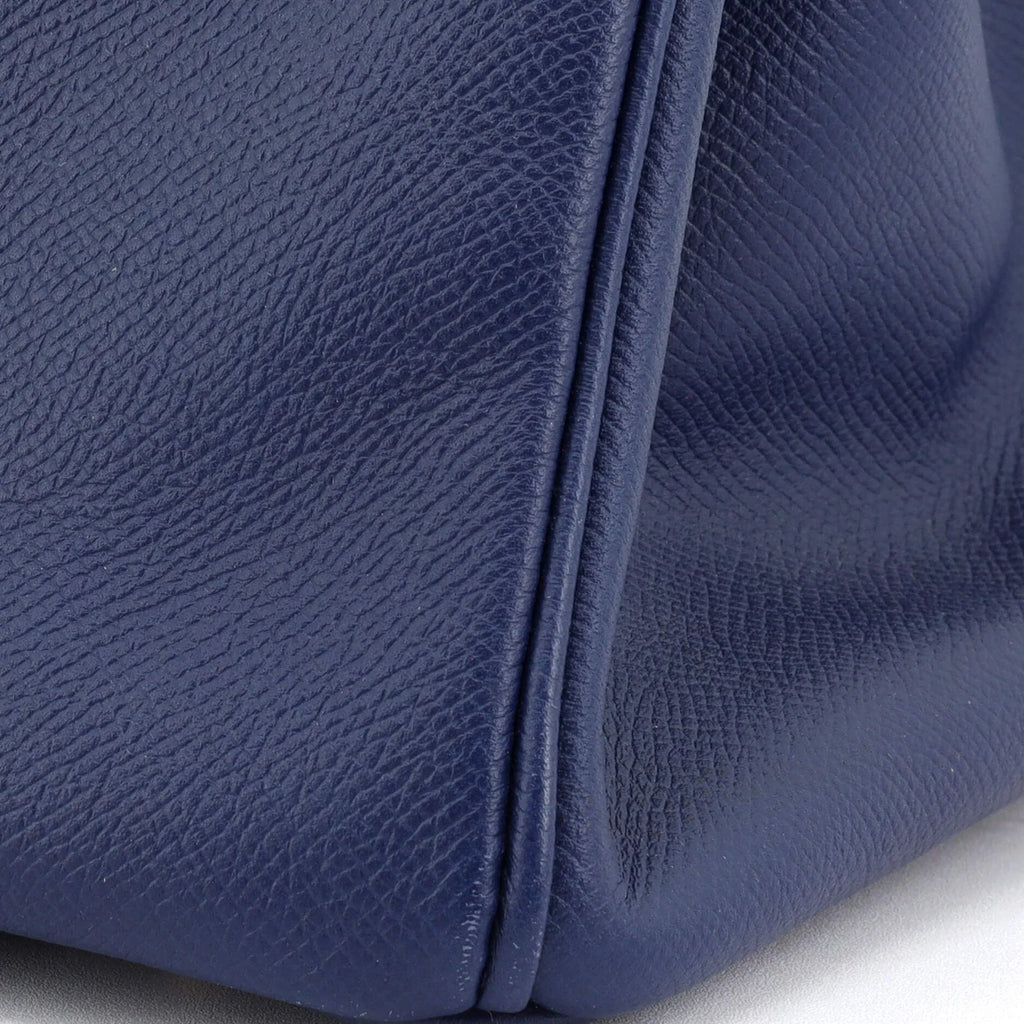 Close-up of a blue Hermes Birkin bag on a white background