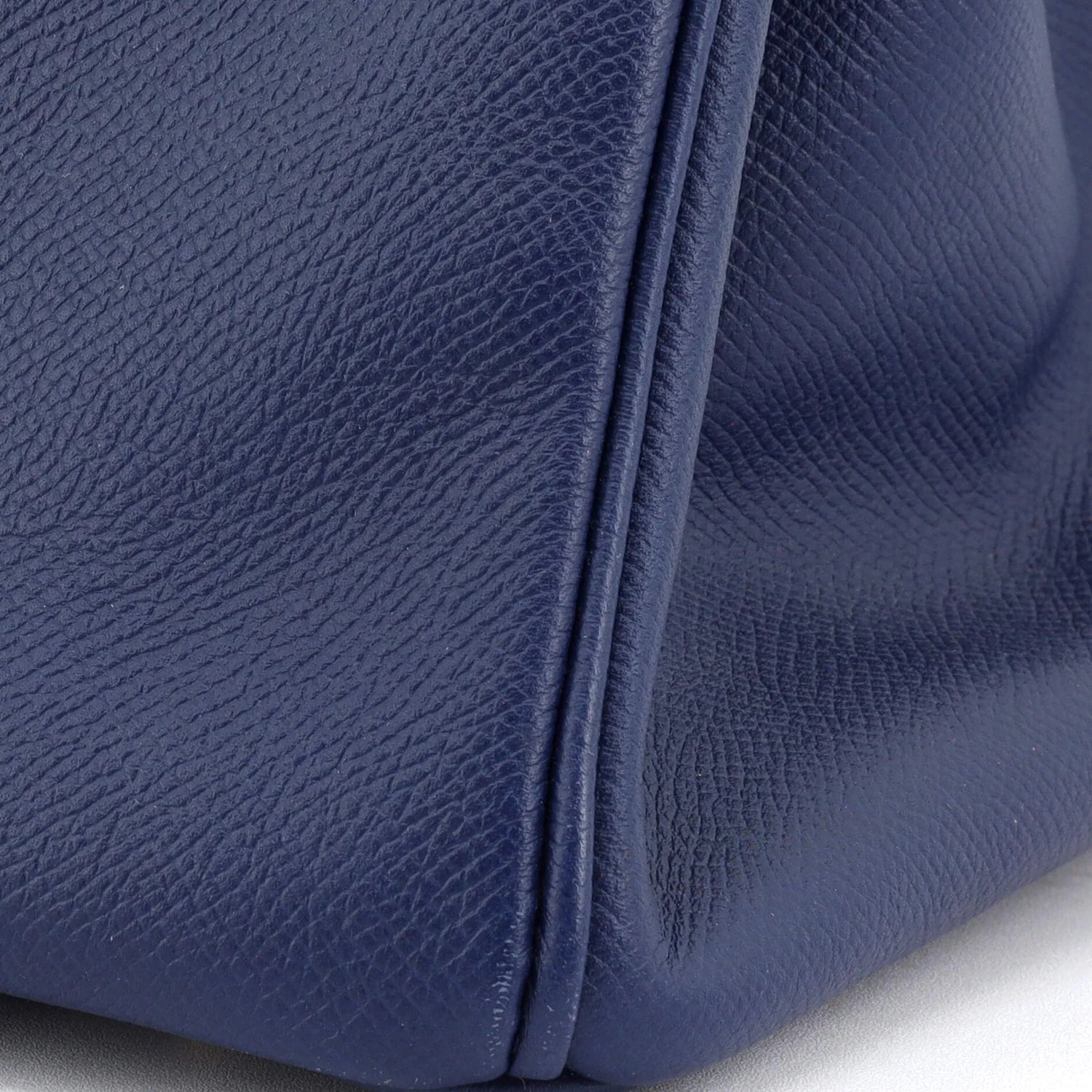 Close-up of a blue Hermes Birkin bag on a white background