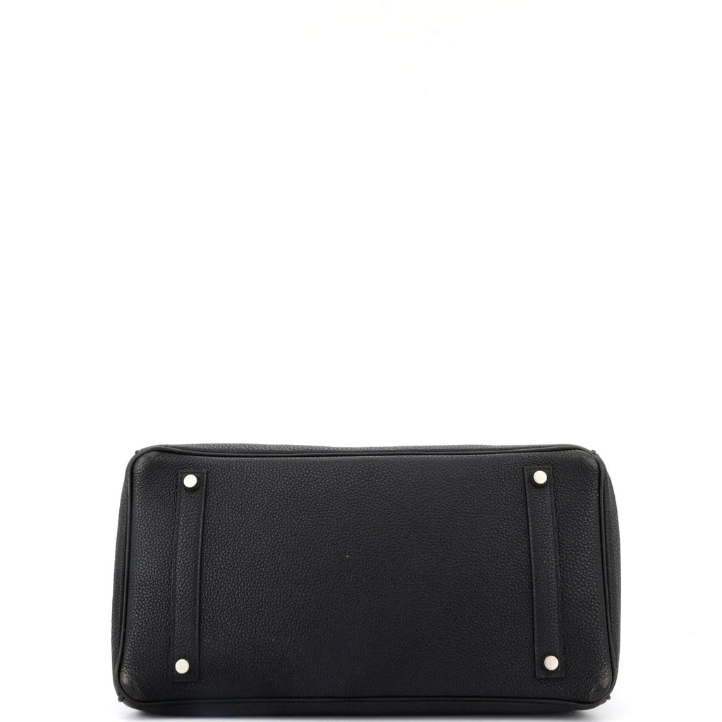 Underside Black Hermes Birkin  bag with silver hardware on a white background