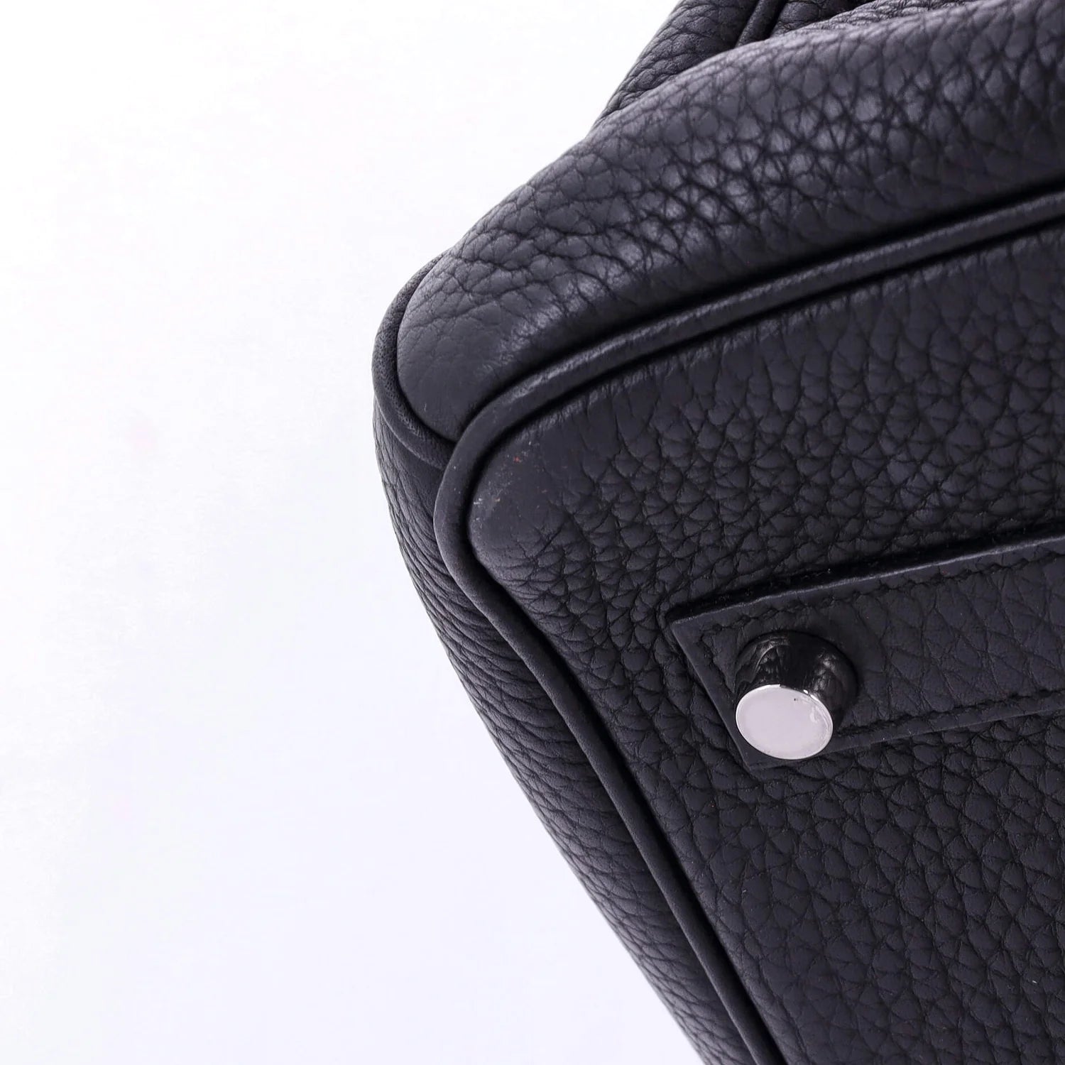Close-up of a black leather Hermes Birkin  bag with a visible brand logo on a white background