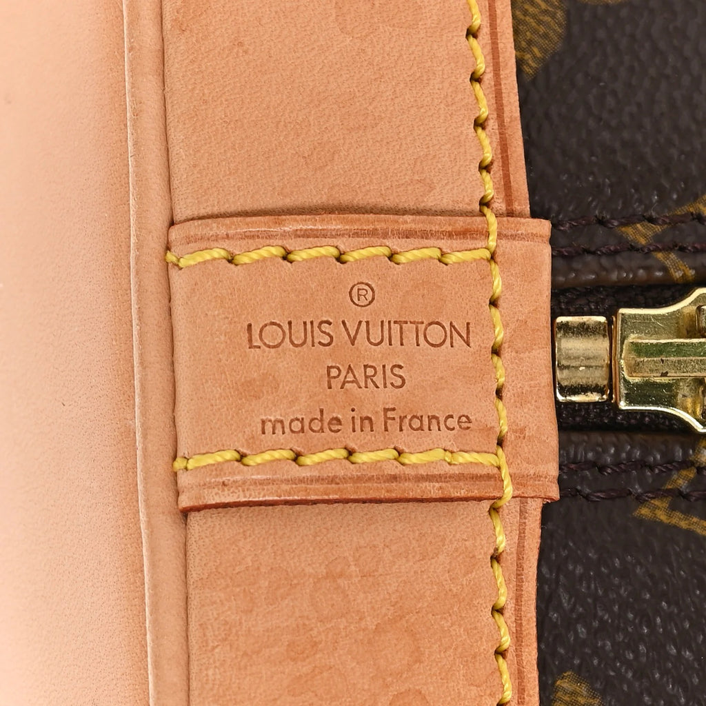 louis vuitton alma pm  leather strap with brand logo and text