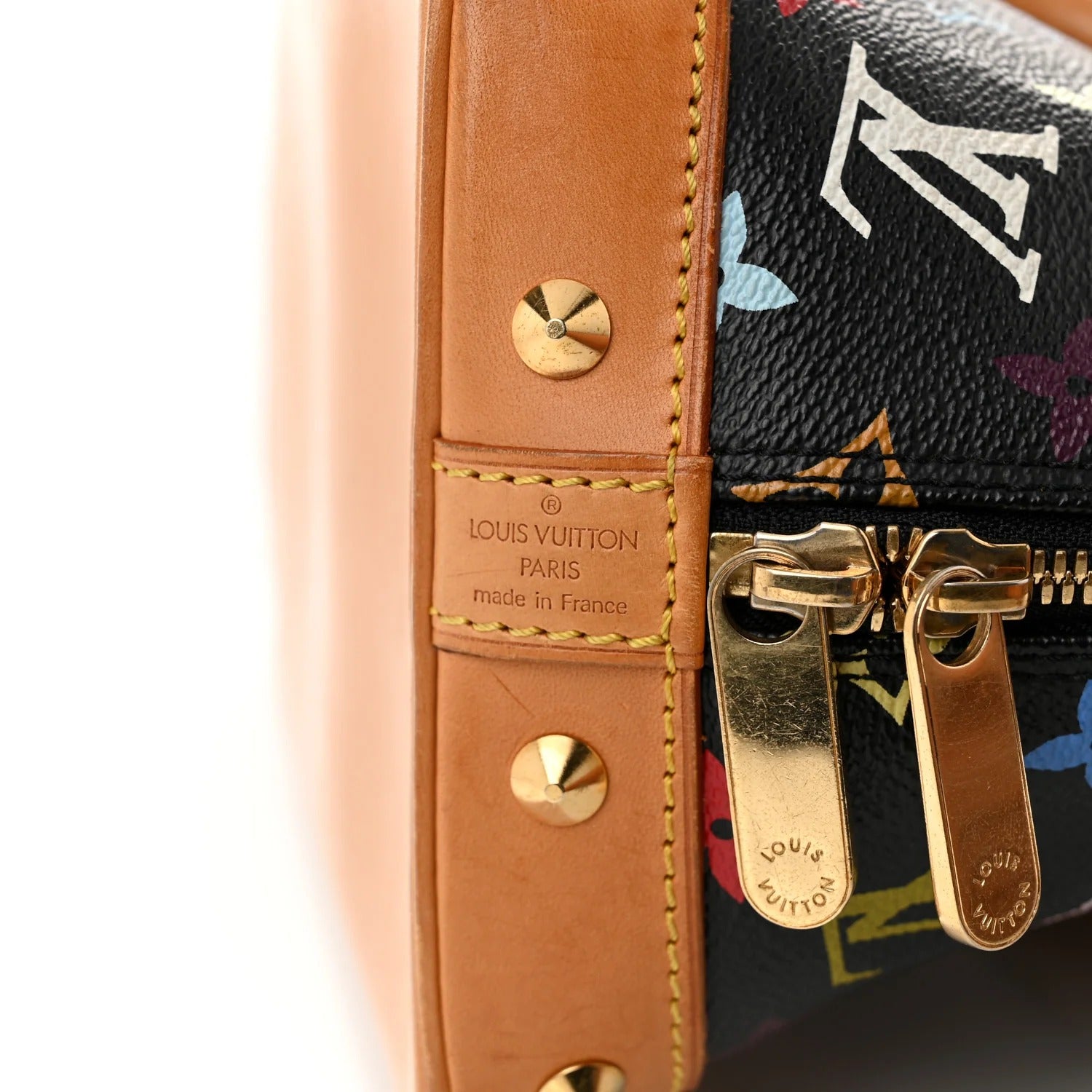 Close-up of a Louis Vuitton handbag with leather strap and gold hardware.