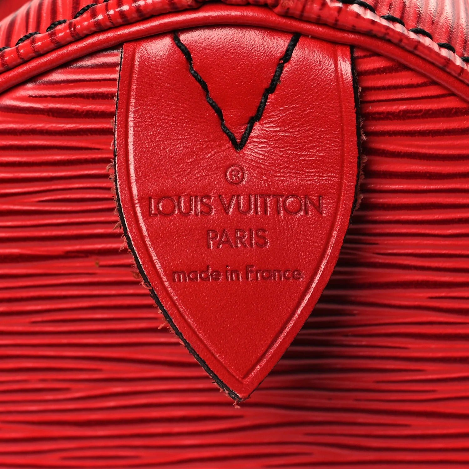 Close-up of a red Louis Vuitton bag with a visible brand logo.