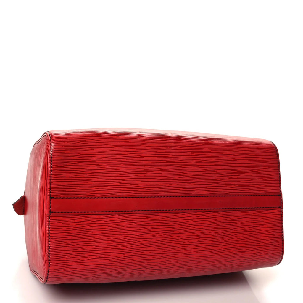 louis vuitton red epi speedy handbag with a textured surface on a white background