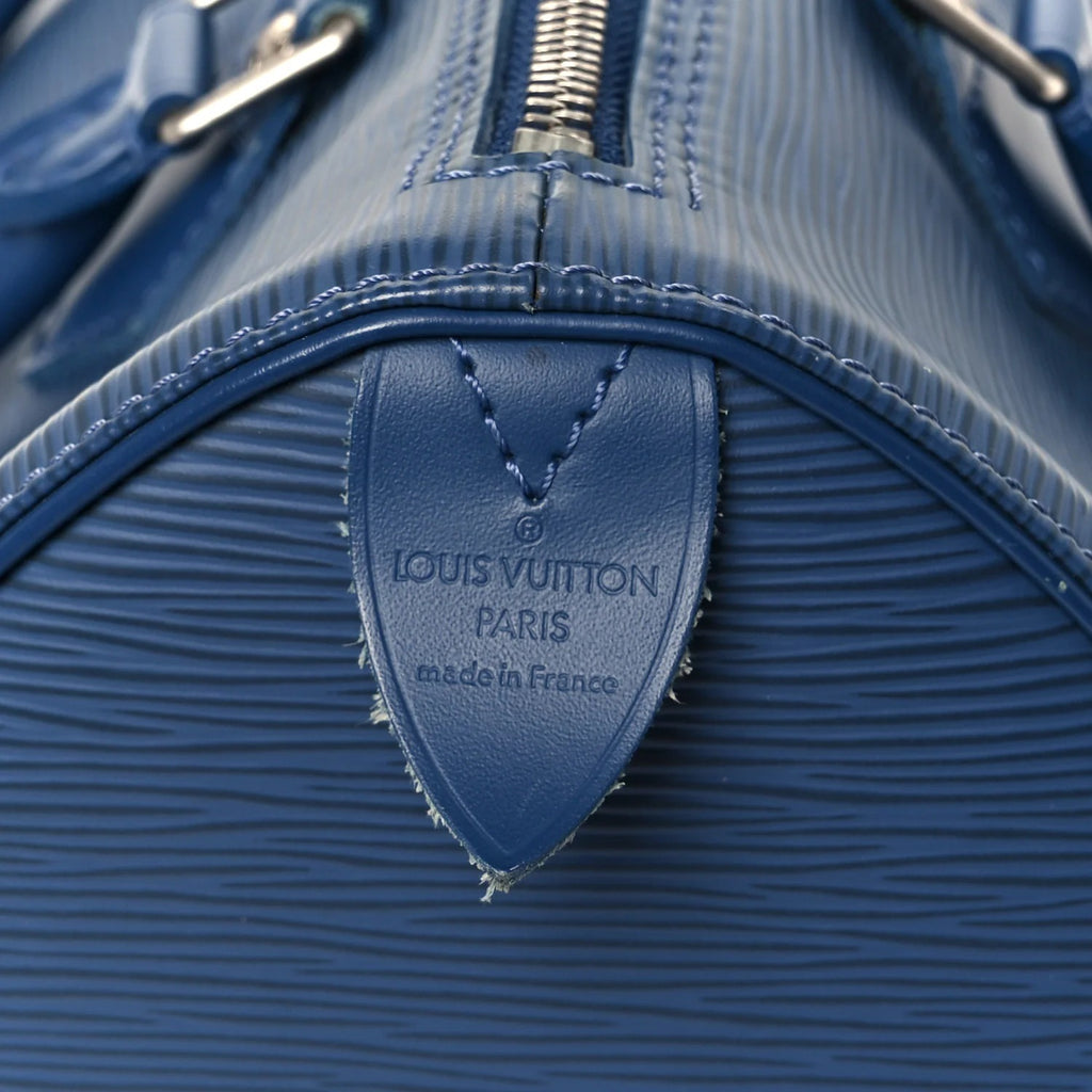 louis vuitton epi speedy blue Close-up of a blue Louis Vuitton bag with brand logo.