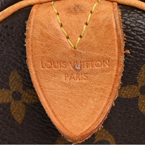 Louis vuitton speedy 35 handbag with monogram pattern vachetta leather tag on a white background