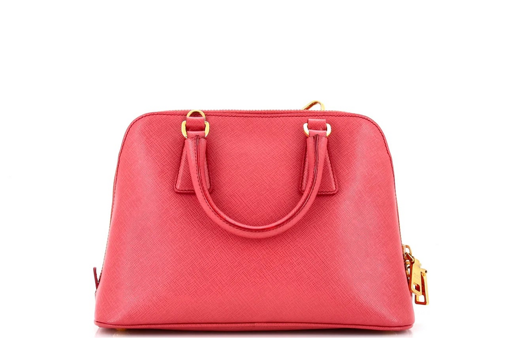 Pink Prada leather handbag with gold accents on a white background