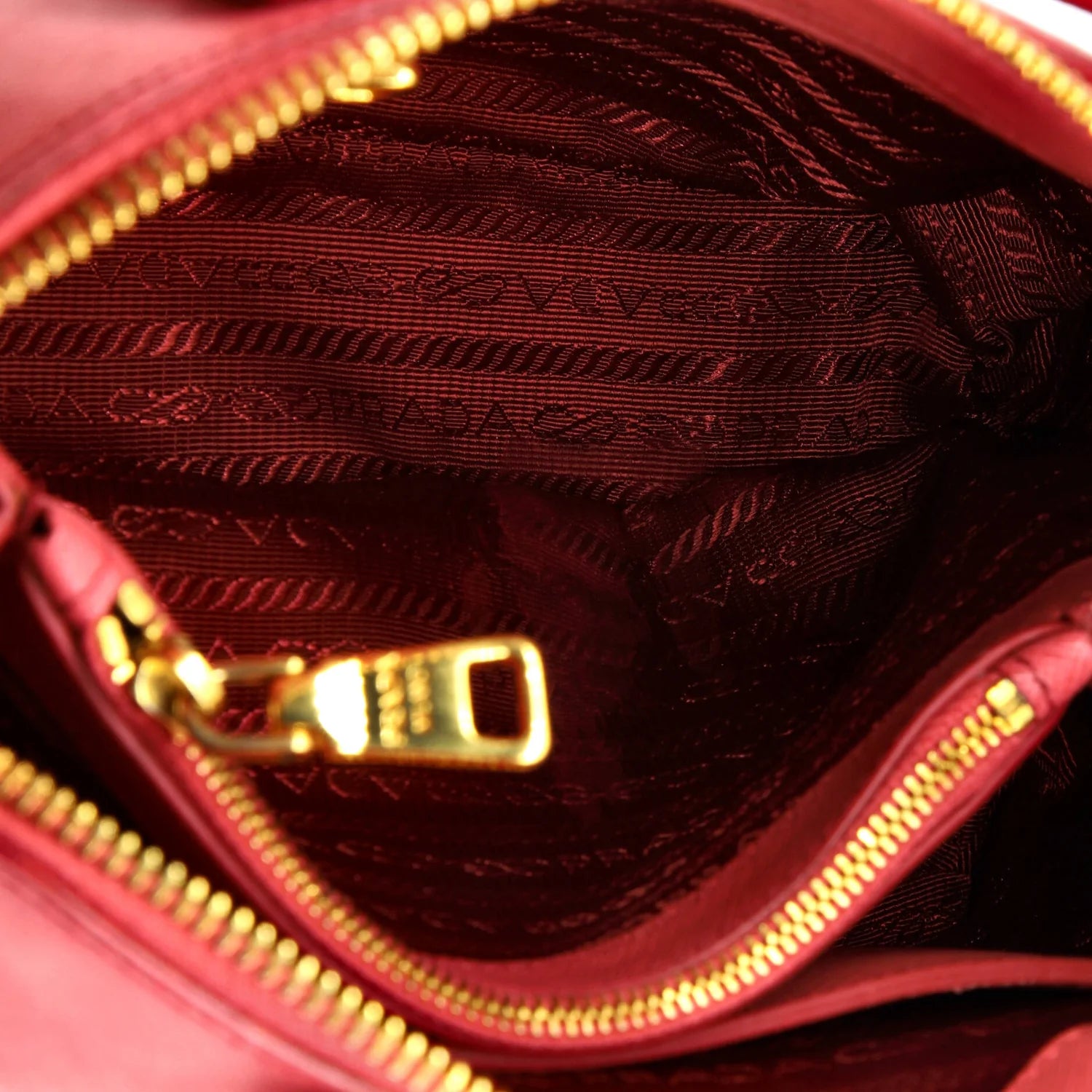 Close-up of a Pink Prada leather handbag interior with gold zipper